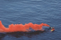 A smoke signal giving off orange-coloured smoke